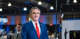 North Dakota Gov. Doug Burgum prepares for a TV interview at the media filing center and spin room at the Pennsylvania Convention Center ahead of the presidential debate between Republican nominee former President Donald J. Trump and Democratic nominee Vice President Kamala Harris in Philadelphia, Pa., on Sept. 10, 2024. Madalina Vasiliu/The Epoch Times