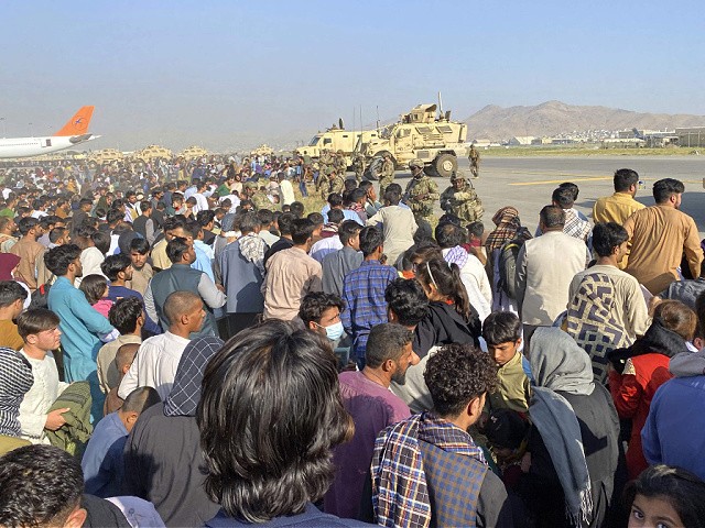 U.S soldiers stand guard along a perimeter at the international airport in Kabul, Afghanistan, Monday, Aug. 16, 2021. On Monday, the U.S. military and officials focus was on Kabul’s airport, where thousands of Afghans trapped by the sudden Taliban takeover rushed the tarmac and clung to U.S. military planes deployed to fly out staffers of the U.S. Embassy, which shut down Sunday, and others. (AP Photo/Shekib Rahmani)