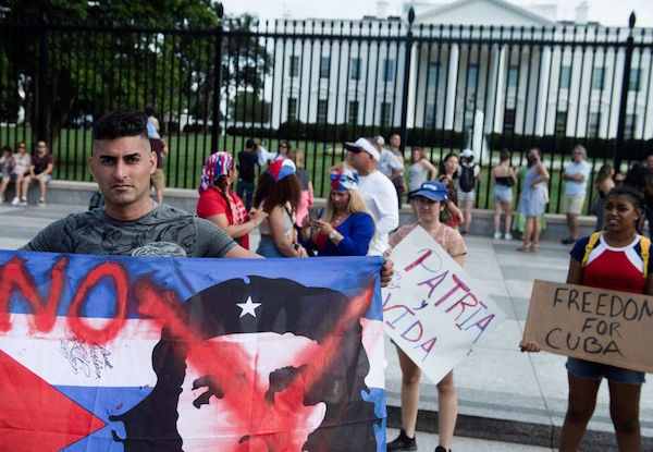 People supporting protests in Cuba gather on Pennsylvania Avenue outside the White House grounds July 13, 2021, in Washington, DC. - Washington warned Haitians and Cubans against trying to flee to the United States as they endure domestic unrest, saying the trip is dangerous and they would be repatriated. (Photo by Brendan Smialowski / AFP) (Photo by BRENDAN SMIALOWSKI/AFP via Getty Images)