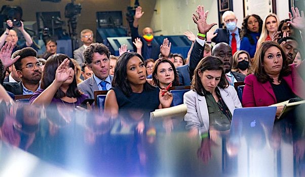Reporters raise their hands during a press briefing by Press Secretary Jen Psaki on Friday, July 16, 2021, in the James S. Brady Press Briefing Room at the White House. (Official White House photo by Erin Scott)